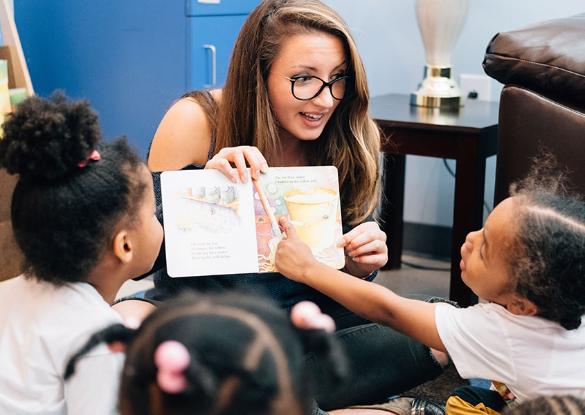 Teacher reading to preschool children