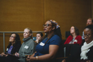 Several individuals listen attentively during presentation.