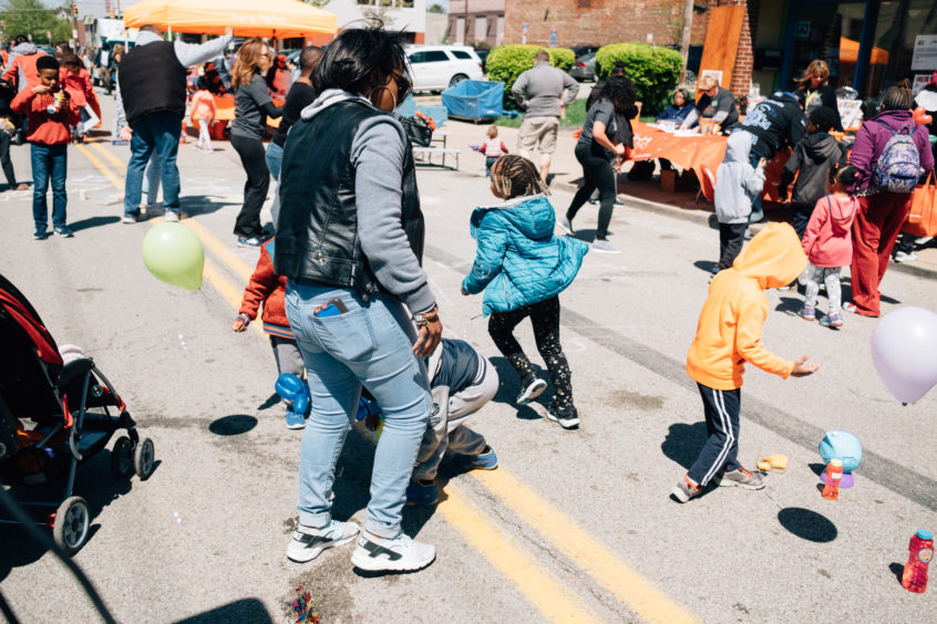 Young children, youth, and adults play happily together in Homewood during the annual block party.