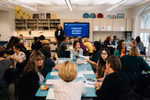 Image: Early childhood professionals sit together at tables, listening to a presenter at a Trying Together UnConference.