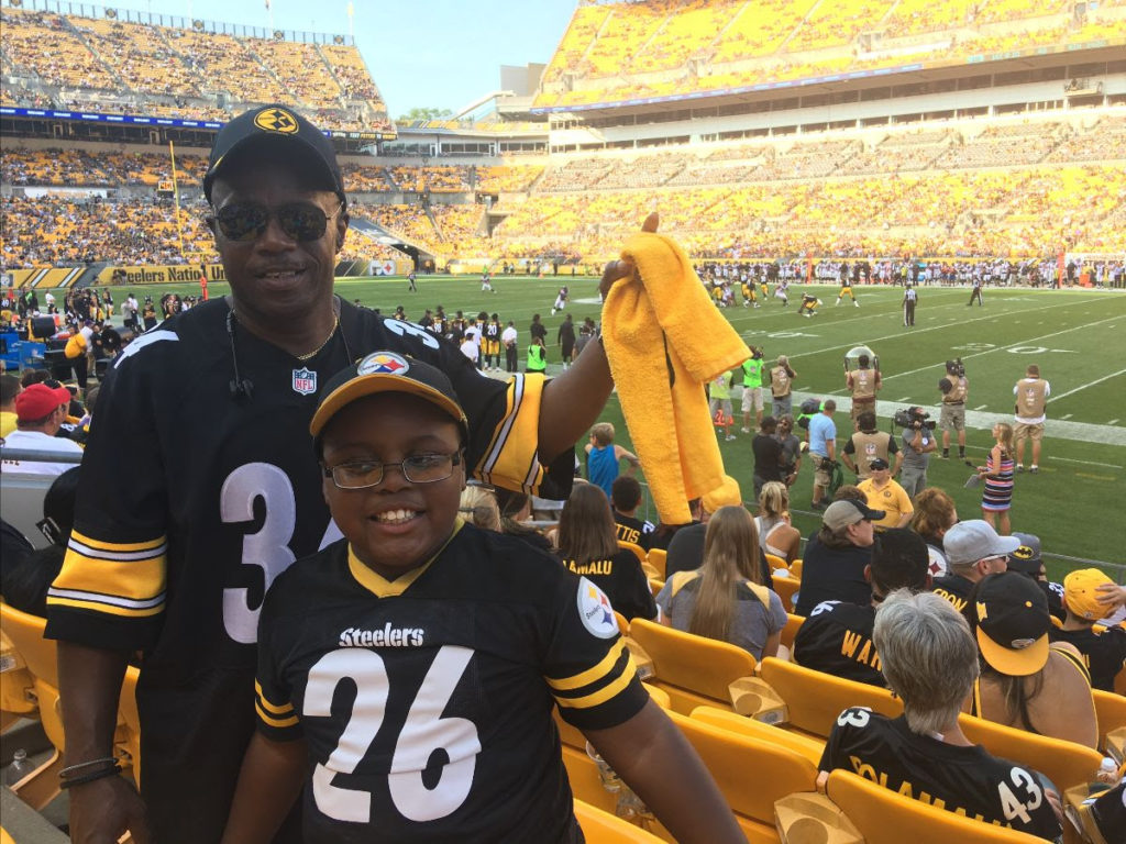 Father and son and a football game wearing jerseys