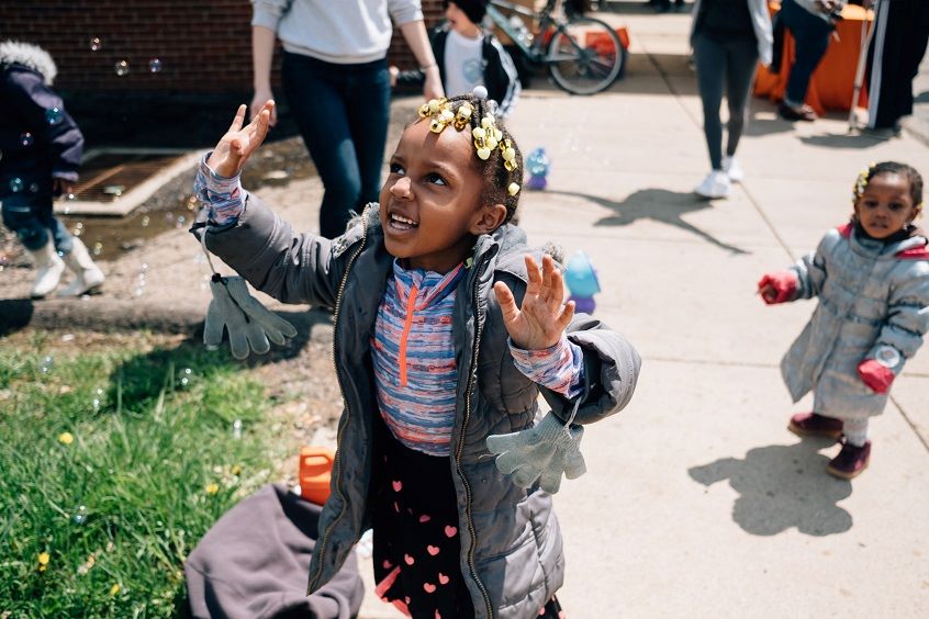 Encouraging Positive Racial Identity in Young Children | A young black girl standing and smiling