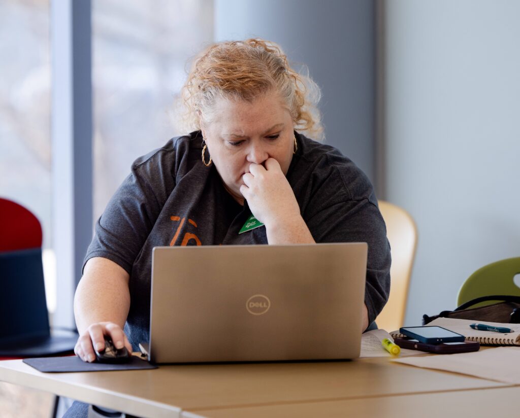 Women sitting at desk, using a computer | Early Childhood Educators Should Update Mandated Reporter Training for New School Year