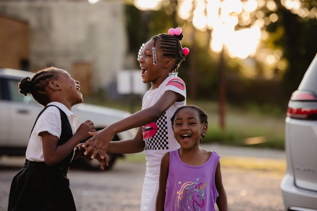 Three young girls smiling and playing | Report Finds That PA Early Learning Shortage Poses Risk to Economy